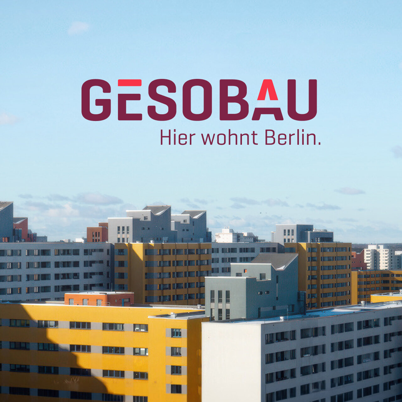 Mehrere mehrst&ouml;ckige Wohnh&auml;user in Gelb, Wei&szlig; und Grau vor blauem Himmel. GESOBAU-Logo mit dem Slogan "Hier wohnt Berlin" dar&uuml;ber. Moderne Architektur der Wohnungsbaugesellschaft in Berlin-Typischer Plattenbauweise.