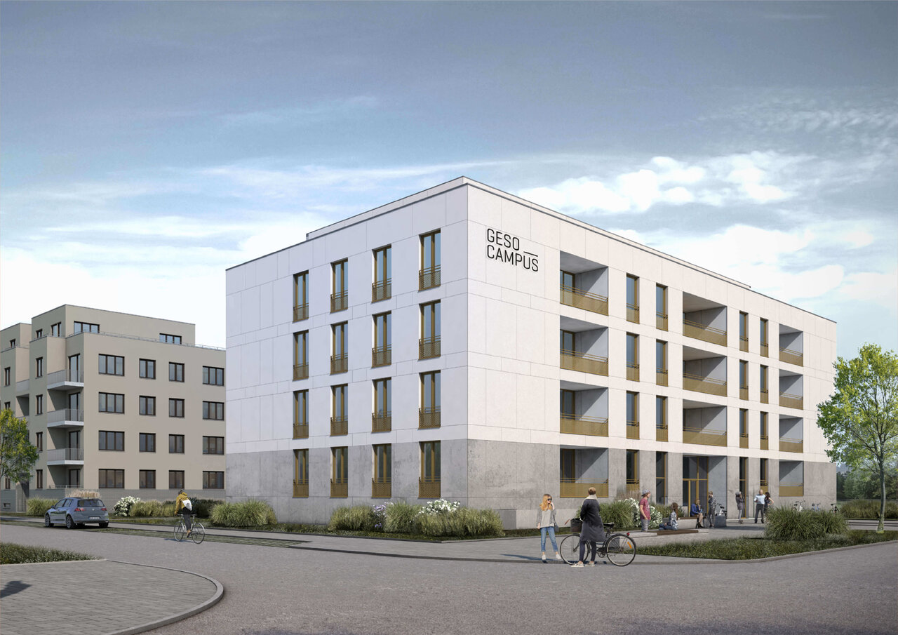 Moderner, kubischer Neubau mit der Aufschrift "GESO CAMPUS" in hellem Beige, umgeben von Gr&uuml;nfl&auml;chen und Stra&szlig;enraum mit Fahrradfahrer und parkenden Autos.